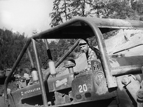 Ray Wallace driving logging equipment.